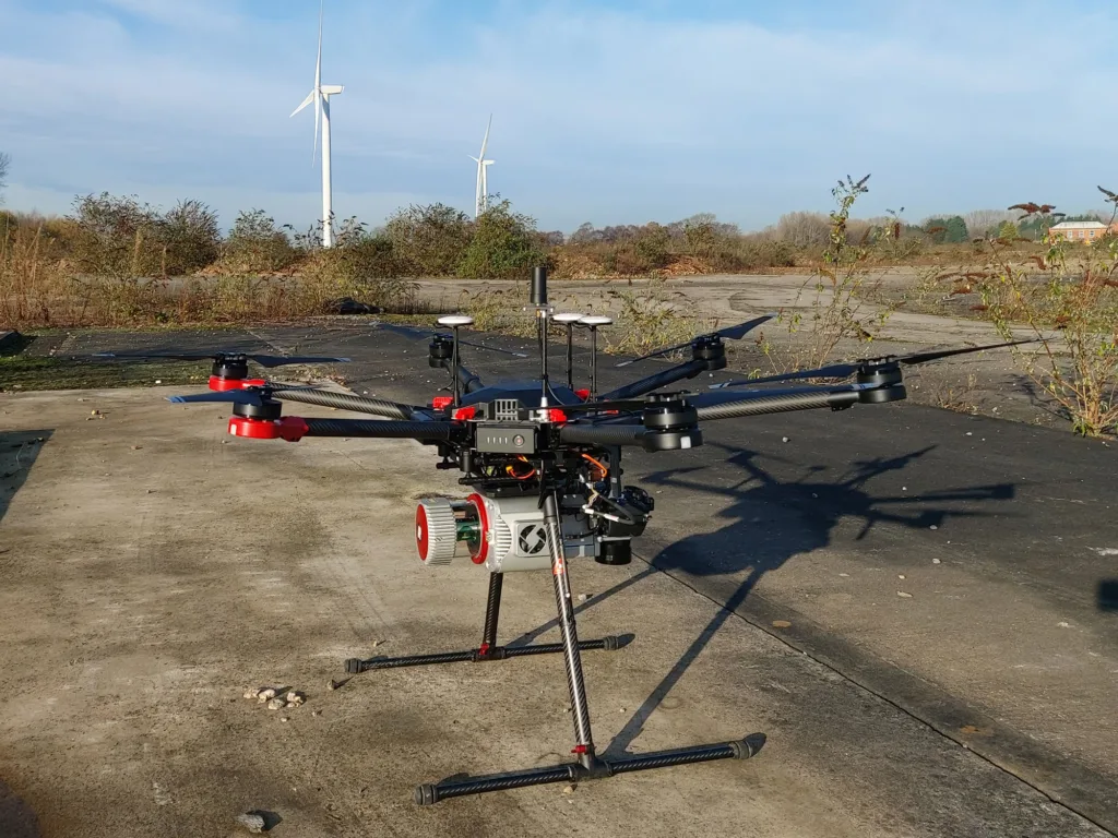 Drone on the ground with wind turbines in the background