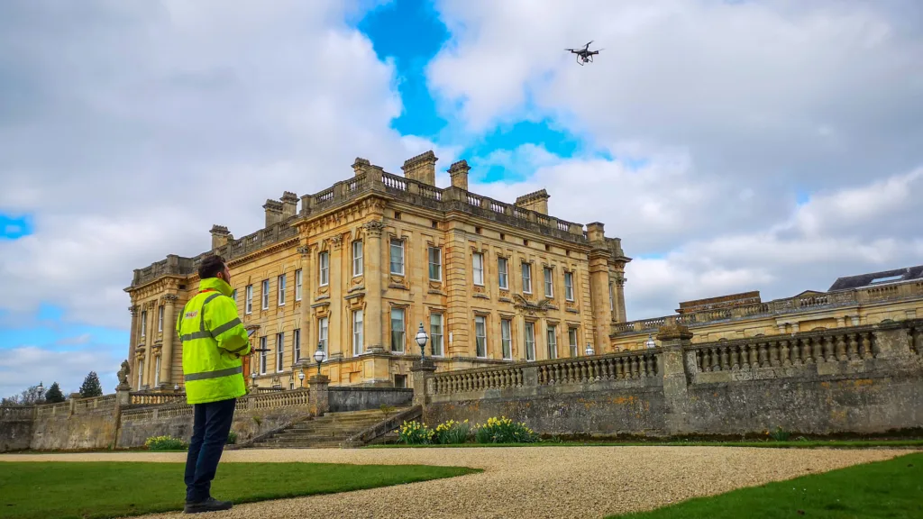 Lewis Hook flying a drone at a large historic house