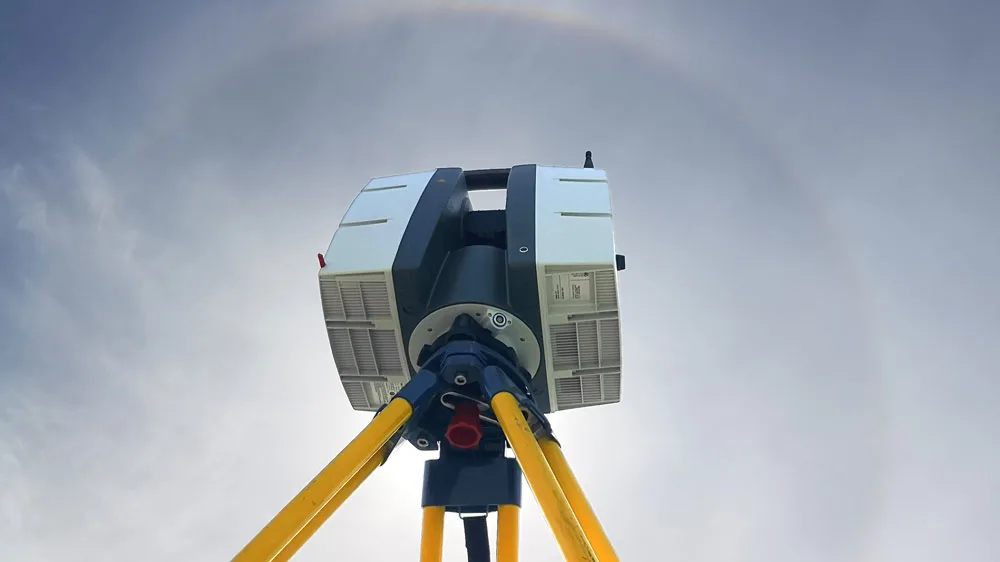3D Laser Scanner on a tripod with halo clouds in the sky behind