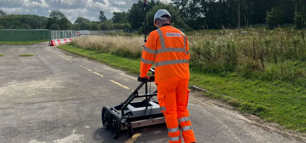 Man pushing a Ground Penetrating Radar for a Underground Utility Survey
